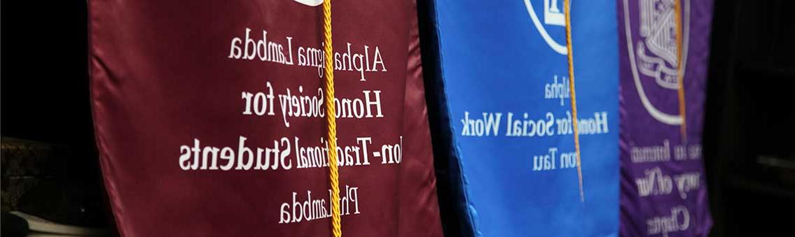 honor society standards displayed at Thomas University commencement